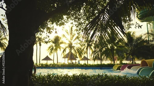 This tropical pool features exciting slides and lovely palm trees, especially beautiful at sunset