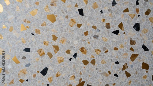 A terrazzo surface with gold and beige chips set in a light gray base