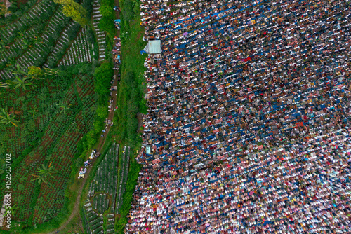 Top view of Thousands gather for Eid al-Adha prayer at Garung Field, Wonosobo, Central Java, June 6, 2025