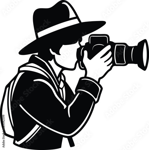 Silhouette of a photographer wearing a hat taking pictures with a professional camera