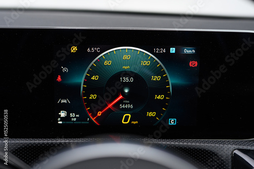A car dashboard shows the speedometer at 135 mph