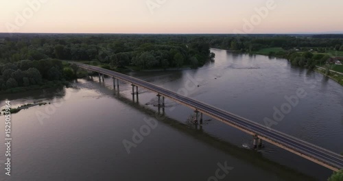 Aerial view of the sunrise on the Drava River with the bridge, Croatia