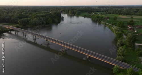 Aerial view of the sunrise on the Drava River with the bridge, Croatia
