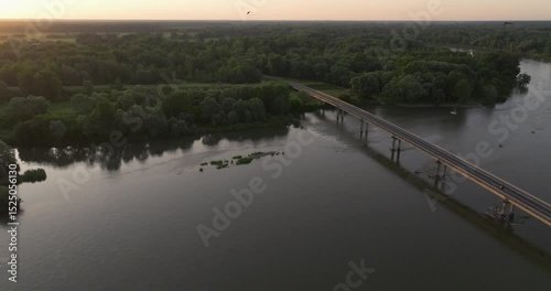 Aerial view of the sunrise on the Drava River with the bridge, Croatia