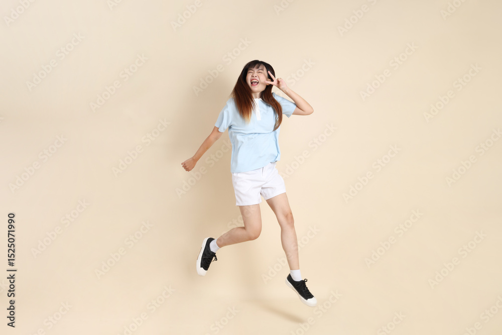 Fototapeta premium 20s Asian Woman in Light Blue Shirt and White Shorts