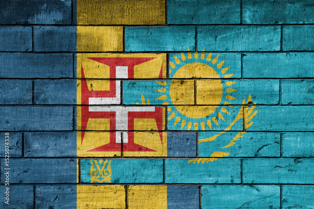 Fototapeta premium colourful painted big national flag of madeira and flag of kazakhstan on a massive old brick wall background. concept