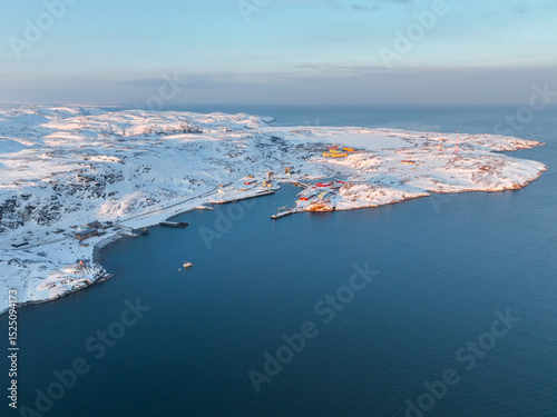 Panoramic aerial view of the snow-covered Teriberka coastline extending into the vast Barents Sea during winter, Russia