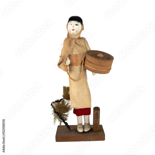 20250608008 Traditional Japanese doll in rustic attire holding a round basket.