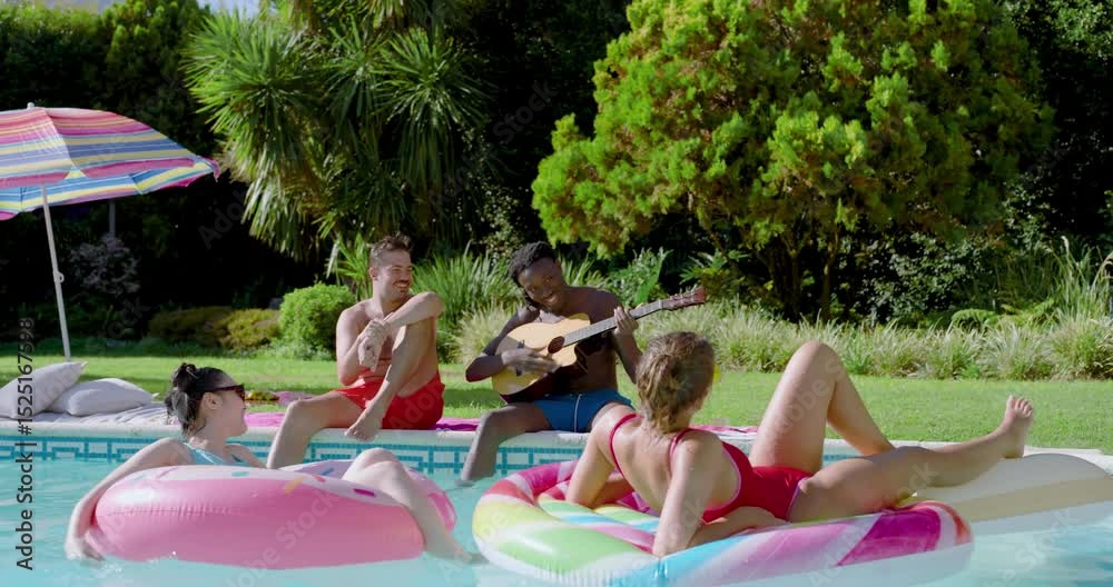 Diverse friends drifting in inflatable rings in pool with guitar strumming causing head bobbing