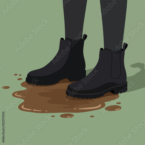 Stylish black chelsea boots standing in puddle of mud. Footwear detail shows fashionable design and chunky sole.  Durable boots perfect for rainy weather.