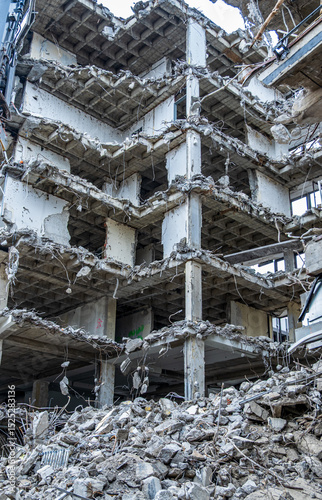 Принти на полотні Destruction visible in a multi-story building collapse amidst rubble and debris