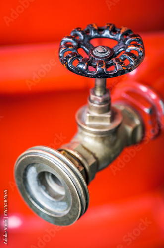 Wallpaper Mural Close-up view of a vintage brass valve against a vibrant red background showcasing intricate design and craftsmanship Torontodigital.ca