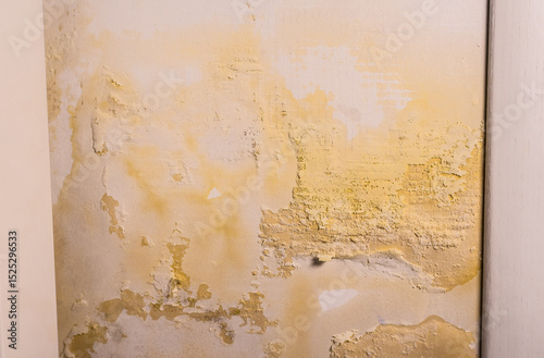 Flooded wall. The wall is peeling near the heating radiator. Pipe leak problem. Renovation concept.