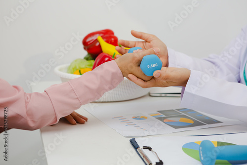 An Asian female nutritionist attentively discusses dietary habits with a patient, offering personalized nutrition advice. She explains healthy food choices, emphasizes balanced meals