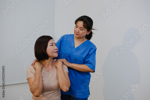 An Asian female physical therapist guides her patient through targeted exercises, promoting recovery and mobility. She provides personalized care, focusing on pain relief