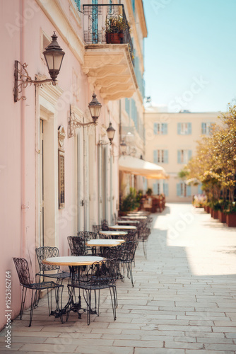 charming europeanstyle outdoor cafe with empty tables featuring single decorative item like vintage lantern