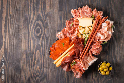 Charcuterie board. Antipasti appetizers of meat platter with salami, prosciutto crudo or jamon and olives.