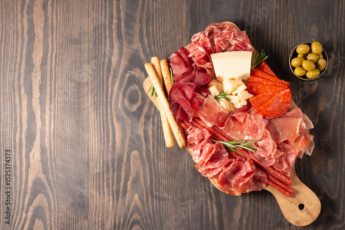 Charcuterie board. Antipasti appetizers of meat platter with salami, prosciutto crudo or jamon and olives.