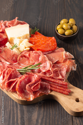 Charcuterie board. Antipasti appetizers of meat platter with salami, prosciutto crudo or jamon and olives.