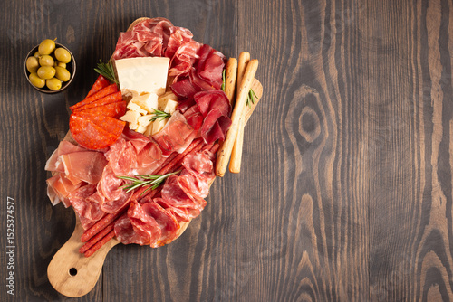 Charcuterie board. Antipasti appetizers of meat platter with salami, prosciutto crudo or jamon and olives.
