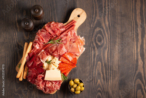 Charcuterie board. Antipasti appetizers of meat platter with salami, prosciutto crudo or jamon and olives.