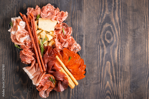 Charcuterie board. Antipasti appetizers of meat platter with salami, prosciutto crudo or jamon and olives.
