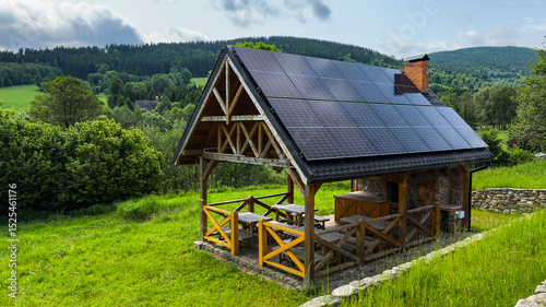 Summer gazebo with solar panels in the mountains on a clear day in summer