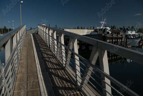 Walking through shadows at gangway in Boat Haven