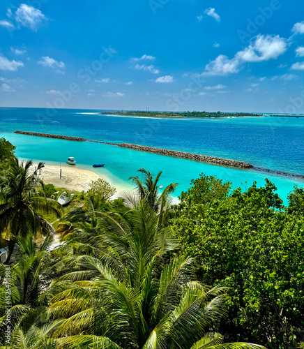 Fototapeta Naklejka Na Ścianę i Meble -  Maldive Islands. A shot of beach on the Maldives. Deserted tropical beach lagoon framed by palm trees. Beautiful nature and white sandy beach on Maldives island, perfect getaway for your vacations. 