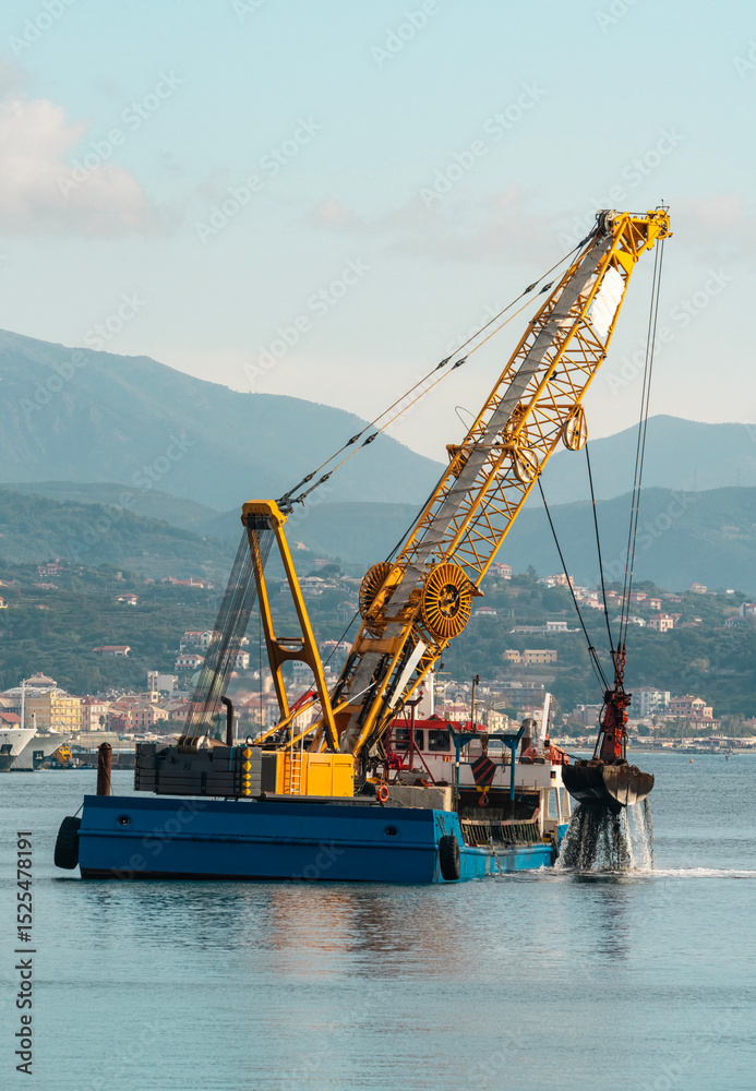 Fototapeta premium Floating crane dredger with grab bucket working in harbor