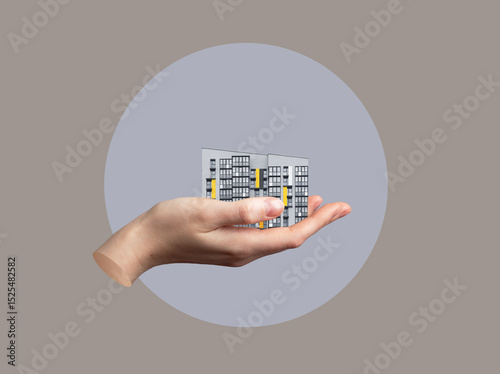 Hand holding large modern apartment building as concept of real estate offer. Symbolic collage