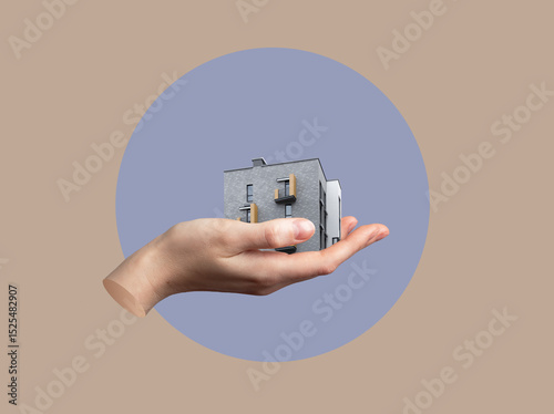 Hand holding modern building as creative concept of urban shelter and real estate. Symbol of