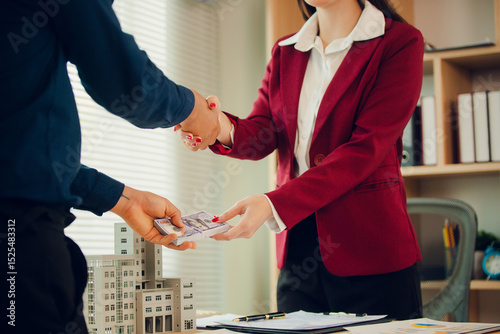 Obraz na plátně Asian businesswoman, house and condo sales agent, handing over keys to clients and signing sales or rental agreements at office