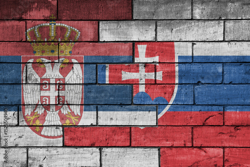 Canvas Print colourful painted big national flag of serbia and flag of slovakia on a massive old brick wall background