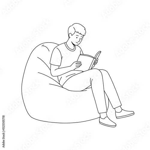 young man reading a book while sitting on bean bag chair in relaxed atmosphere