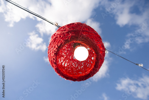 Red decoration with a light bulb inside for the feast of Saint John.