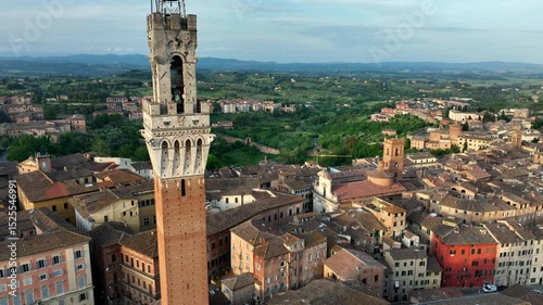 orbiting drone shot of Siena town in Tuscany, Italy, aerial view of Torre del Mangia in Siena, travel in Italian region of Tuscany