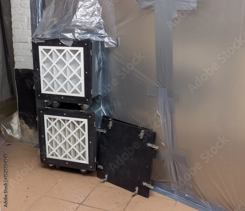 Asbestos removal with filtered air extraction