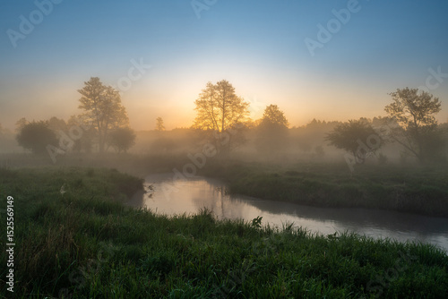 Serene Sunrise Over Misty River