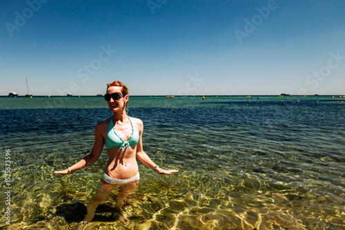 St. Tropez, France - July 7, 2014: A woman enjoying the water along the shores of St. Tropez, France
