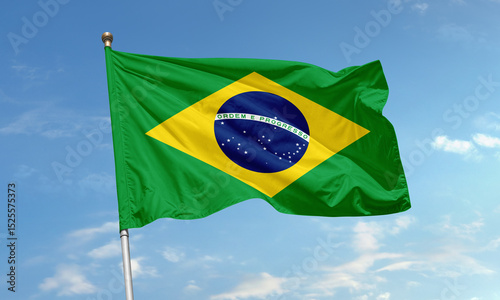 Brazil national flag with green field, yellow diamond and starry blue globe waving proudly in the clear sky
