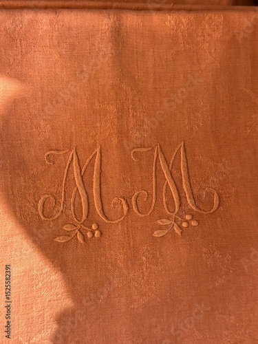 Embroidered Terracotta Linen with Monogrammed 'M M' Initials and Floral Detail

