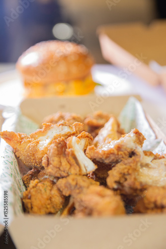 Korean deep dried chicken in paper brown take out box.