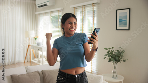 Asia young adult black people humor bizarre funny dance good news at home living room happy joy job hired interview result on mobile, award bonus, win luck bet online game order trade, loan money.