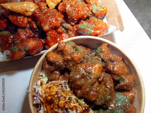 Korean deep dried chicken on white rice with soy garlic sauce.