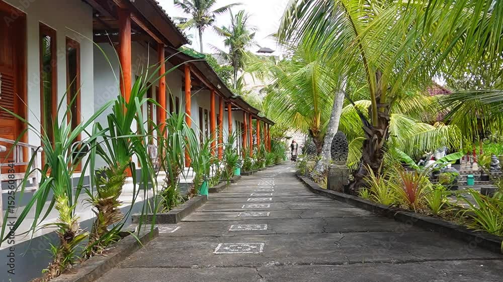 The girl is walking around the tropical hotel. The girl is walking around the tropical hotel.