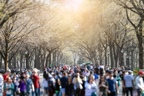 Colorful crowd of people casually walking in Central Park, New York City