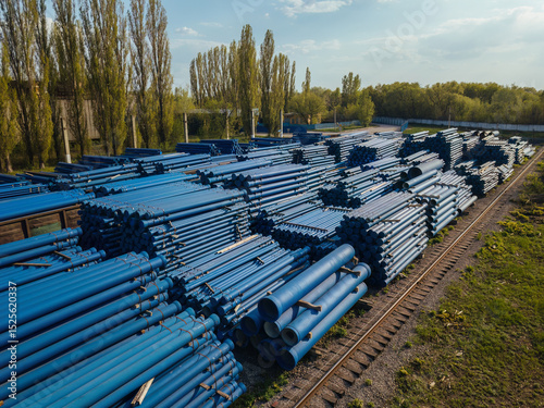 Wallpaper Mural Stack of cast iron pipes in loading area waiting for transportation, drone aerial view Torontodigital.ca