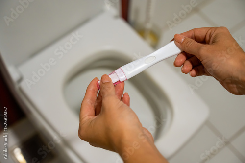A woman takes an express pregnancy test.