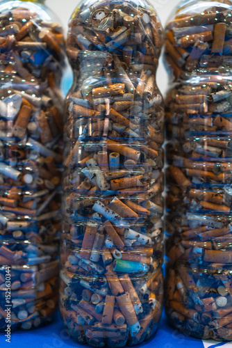 Plastic bottles showing cigarette butts collected from beach cleanup